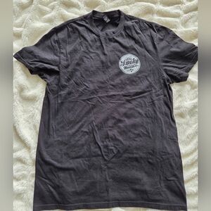 graphic t-shirt from Ole Smoky Moonshine. It features a circular white logo